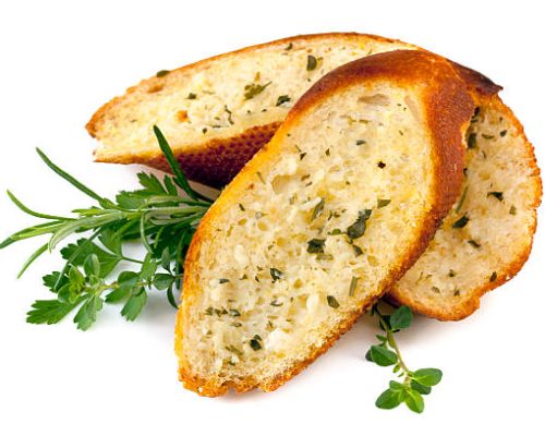 Garlic bread with herbs, isolated on white.